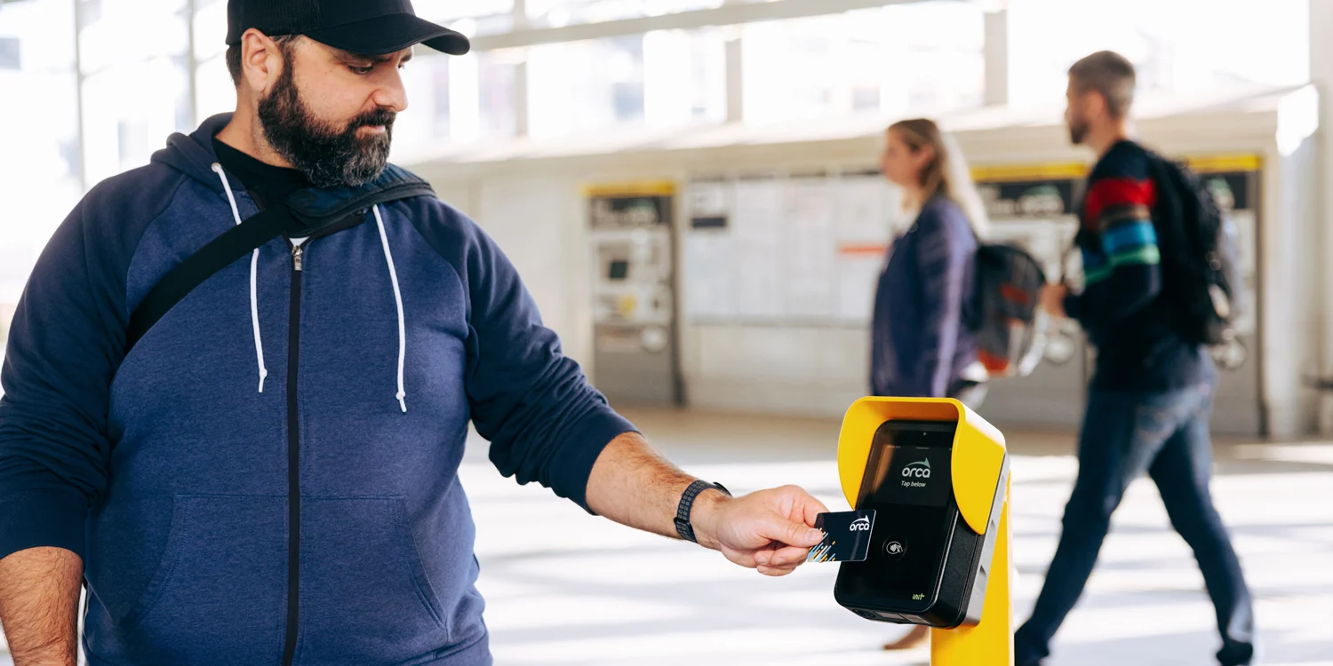 A commuter scans his ORCA card.