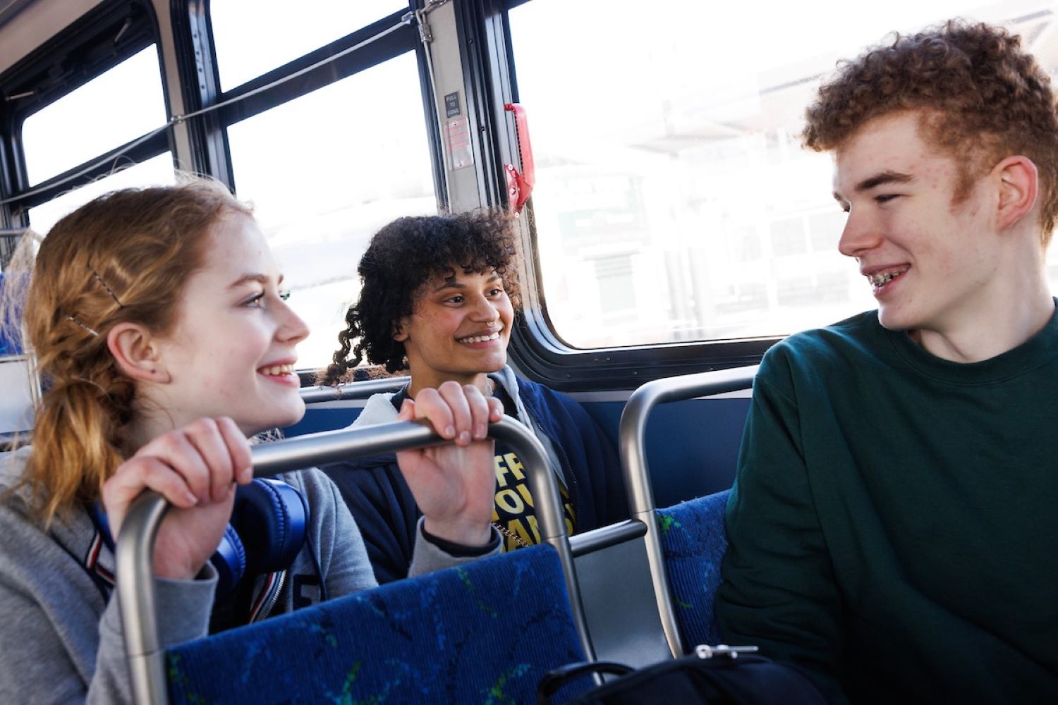 Apollo chats with his friends on the bus.