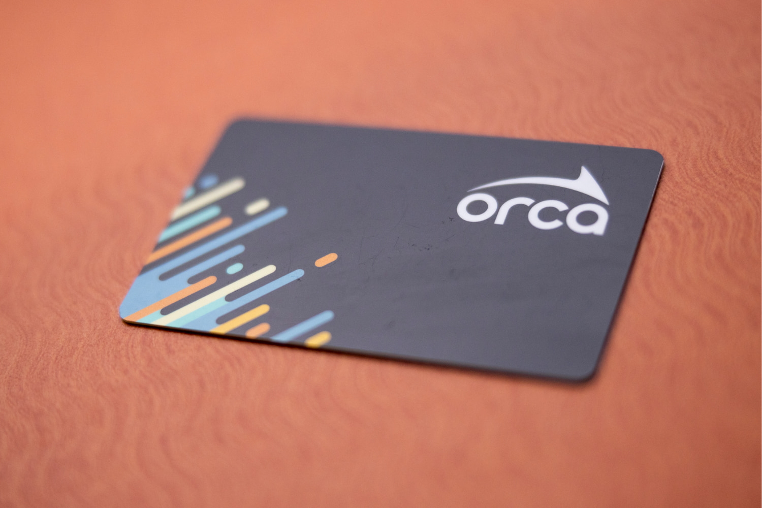 ORCA card with black background on a rusty-red background