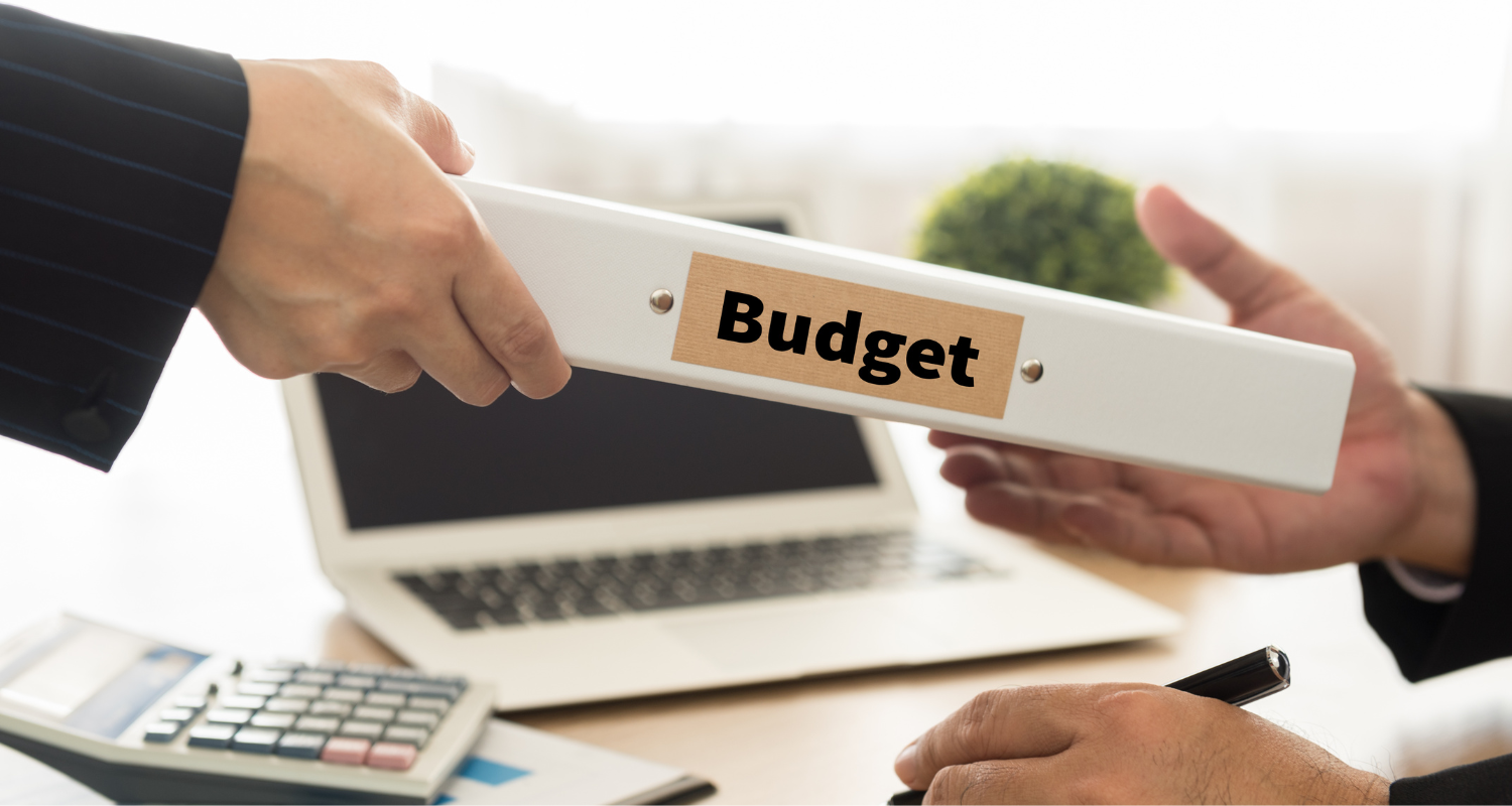 A budget binder is shared between colleagues