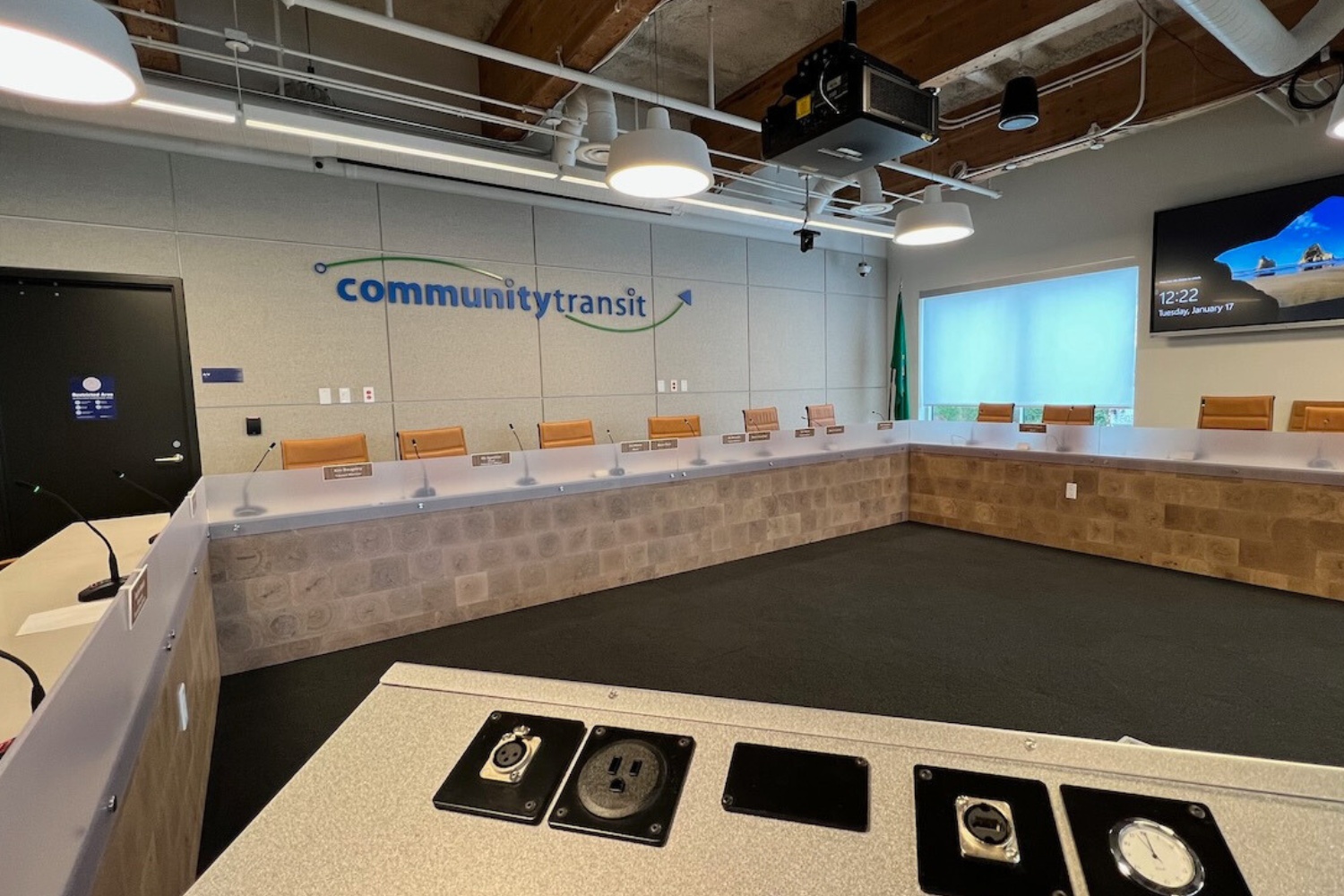 An empty board room with Community Transit's logo on the wall.