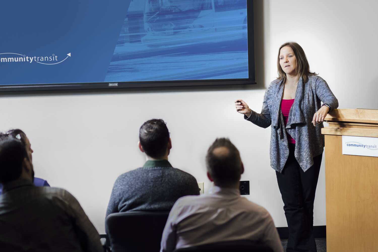 An employee presents to a group of people.