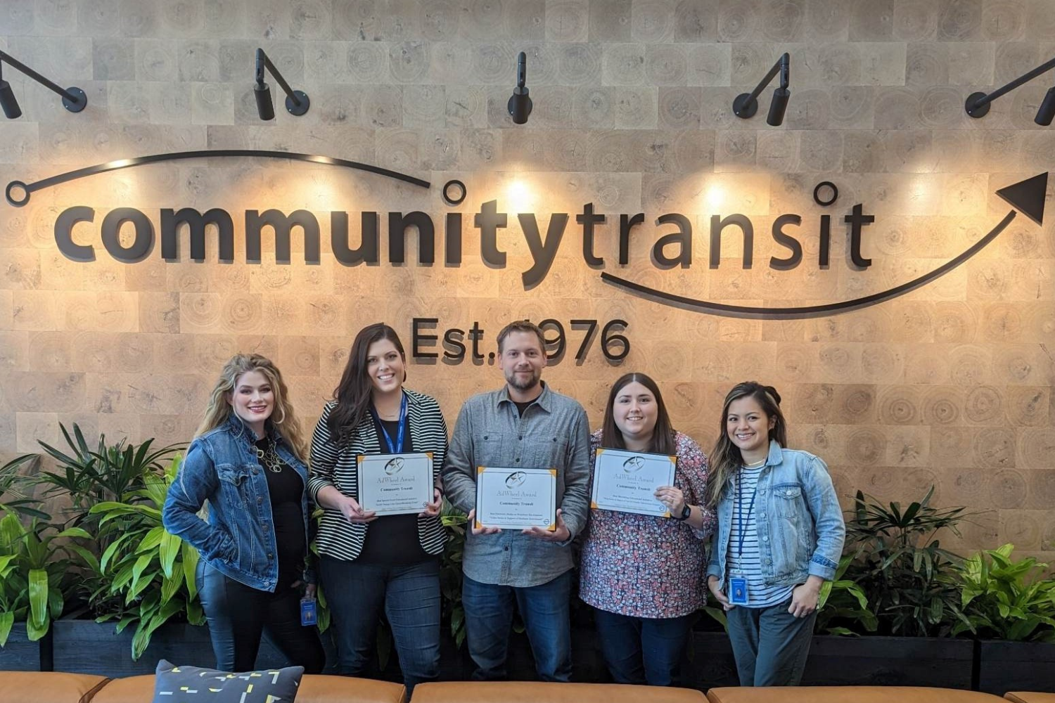 Employees pose with their AdWheel awards. 