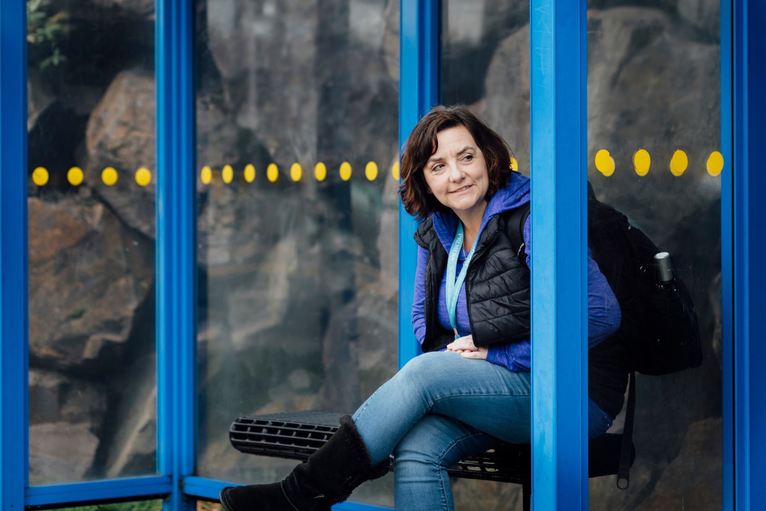 A woman waiting at a bus stop