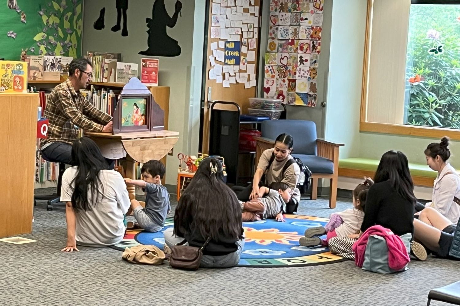 A group of adults and children gathered together for Japanese Family Story Time. 