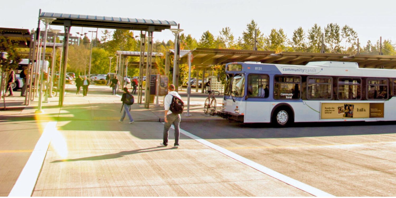 A summer day at Lynnwood Transit Center with a Community Transit bus waiting for commuters using the crosswalk