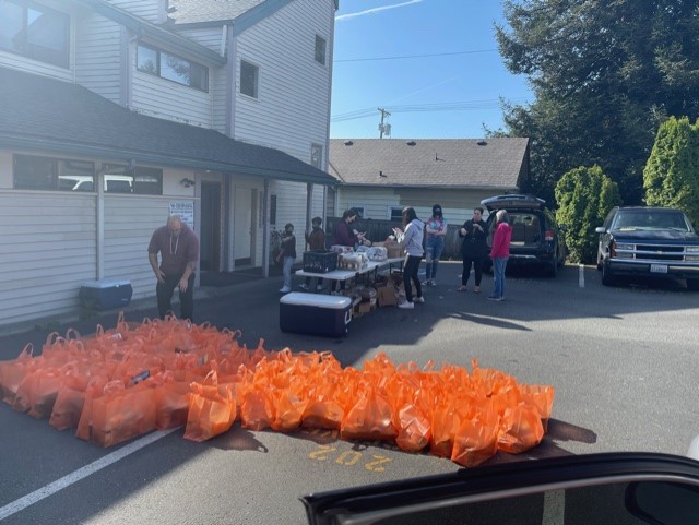 Volunteers help organize food donations. 