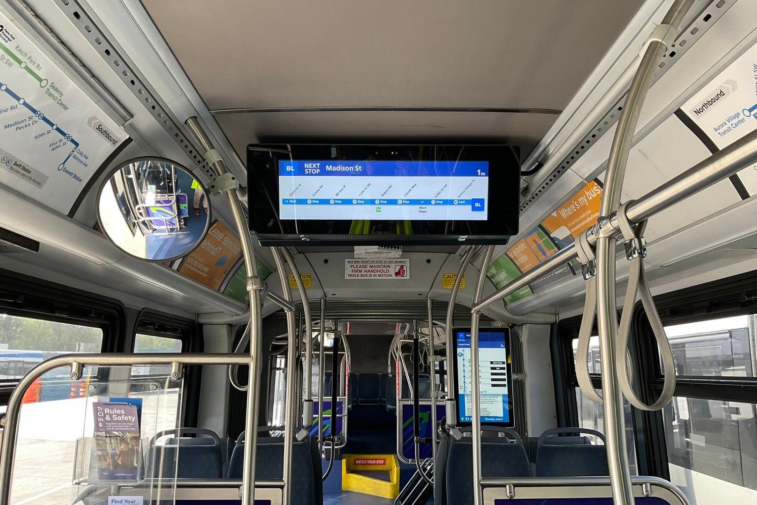 Digital signage installed on the ceiling of a Community  Transit bus. The agency is testing two types of signs and is asking customers for feedback.