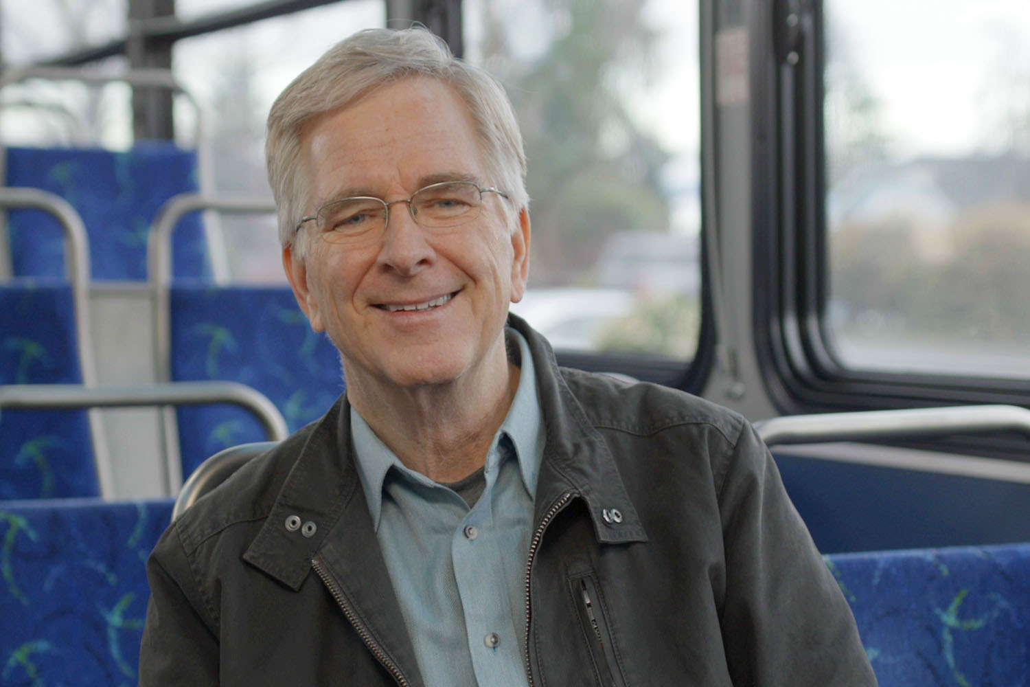 RIck Steves sitting in a Community 
     Transit bus