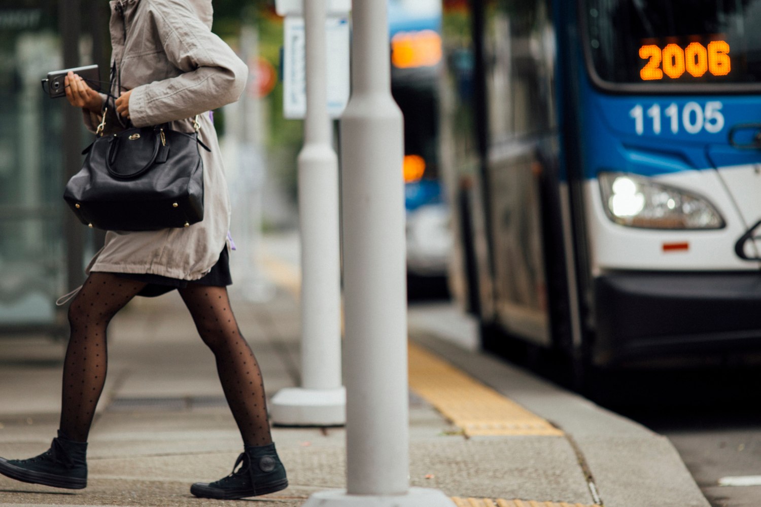 A person getting off the bus at a transit station