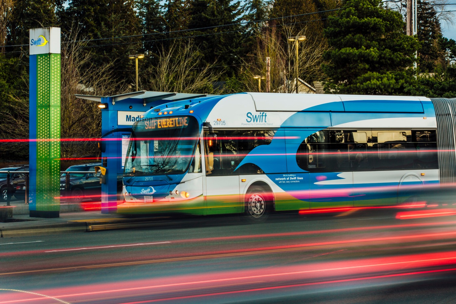 A photo of a Swift bus in Everett, shown with laser-like lighting effects