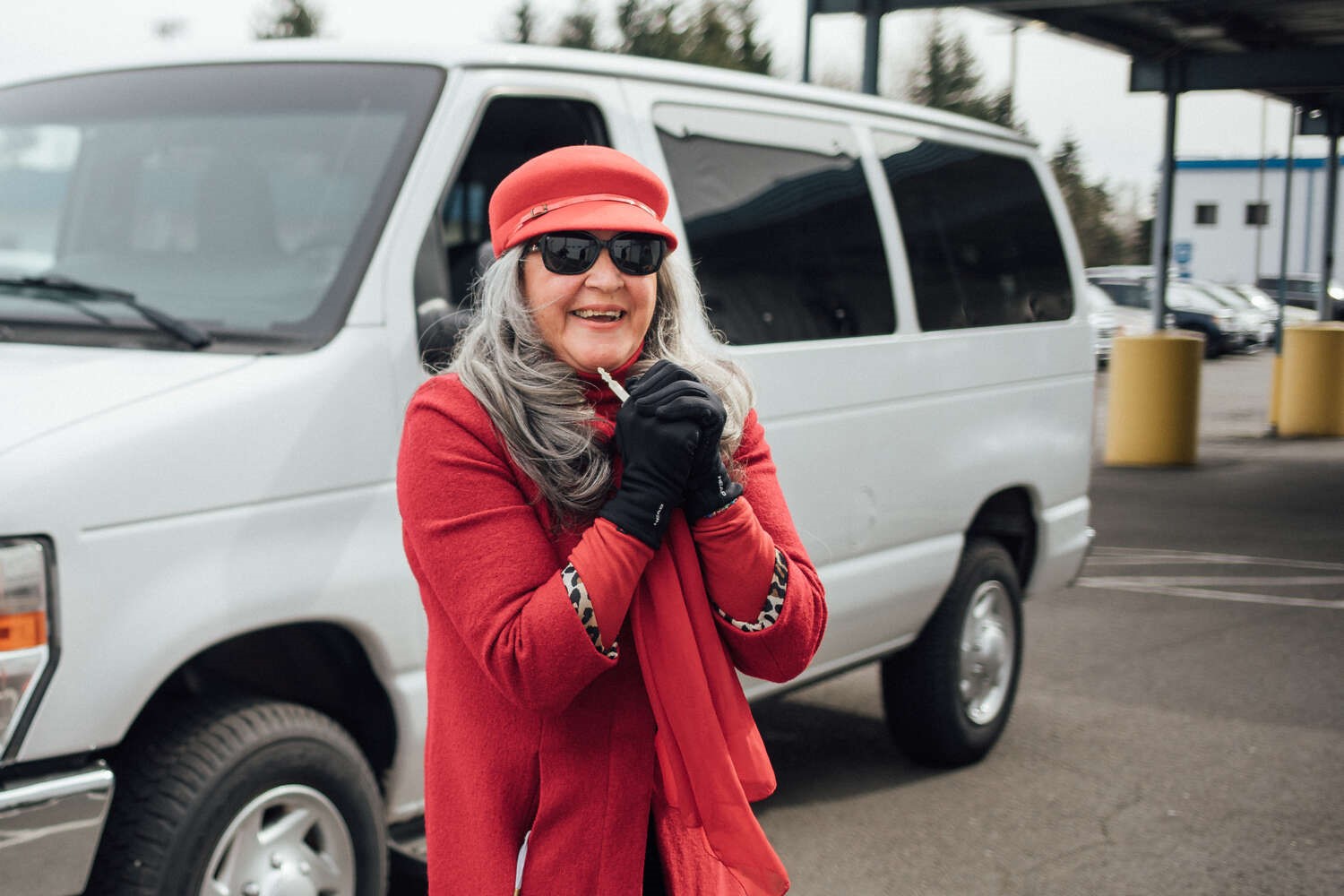 Mari's Place founder Mary Towes smiles in front of the van her organization was granted through Van GO.