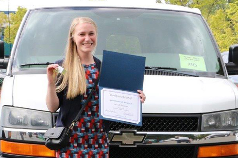 Lynsey Gagnon smiles with keys to the van her organization was granted through Van GO. 