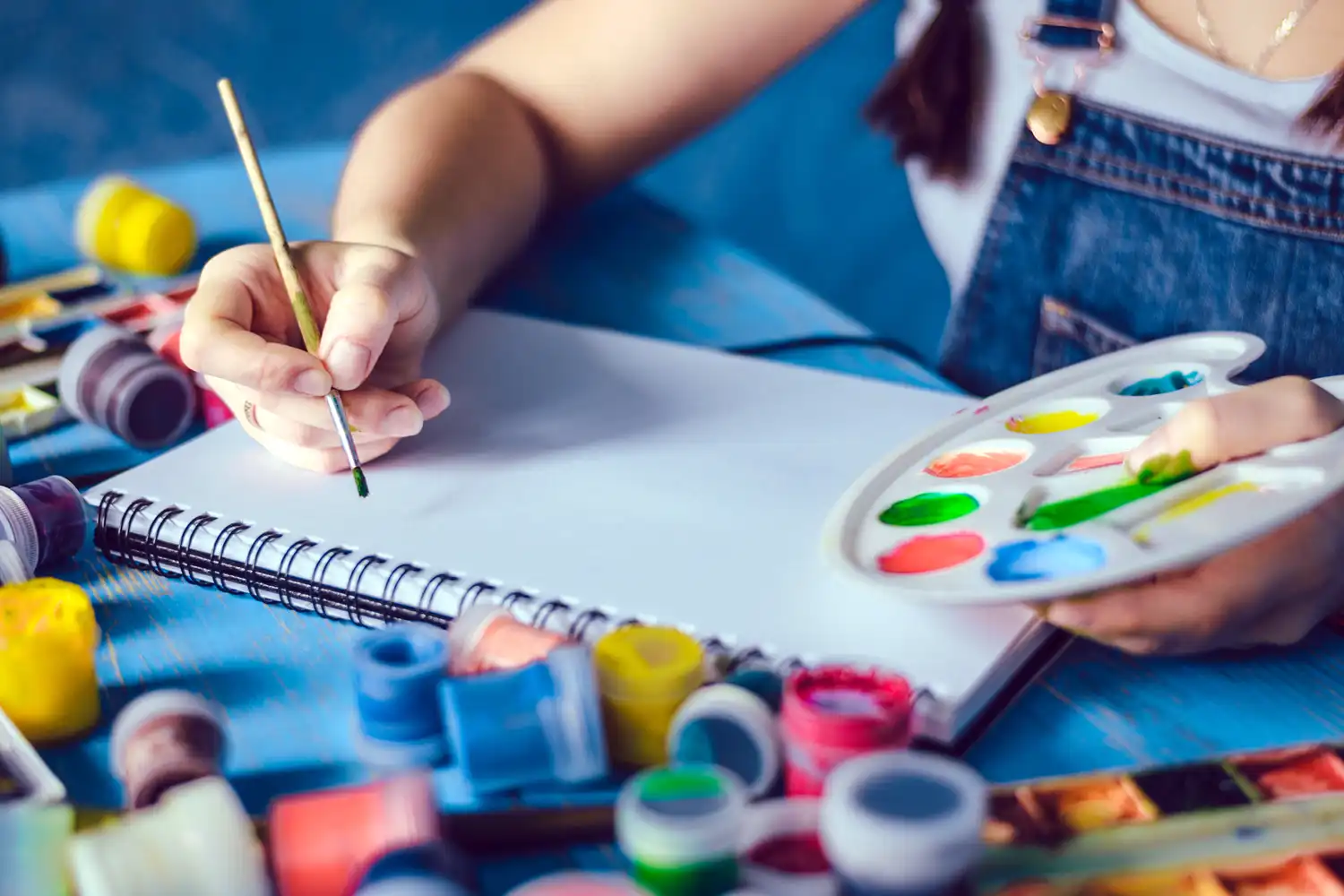 Young girl painting with watercolors