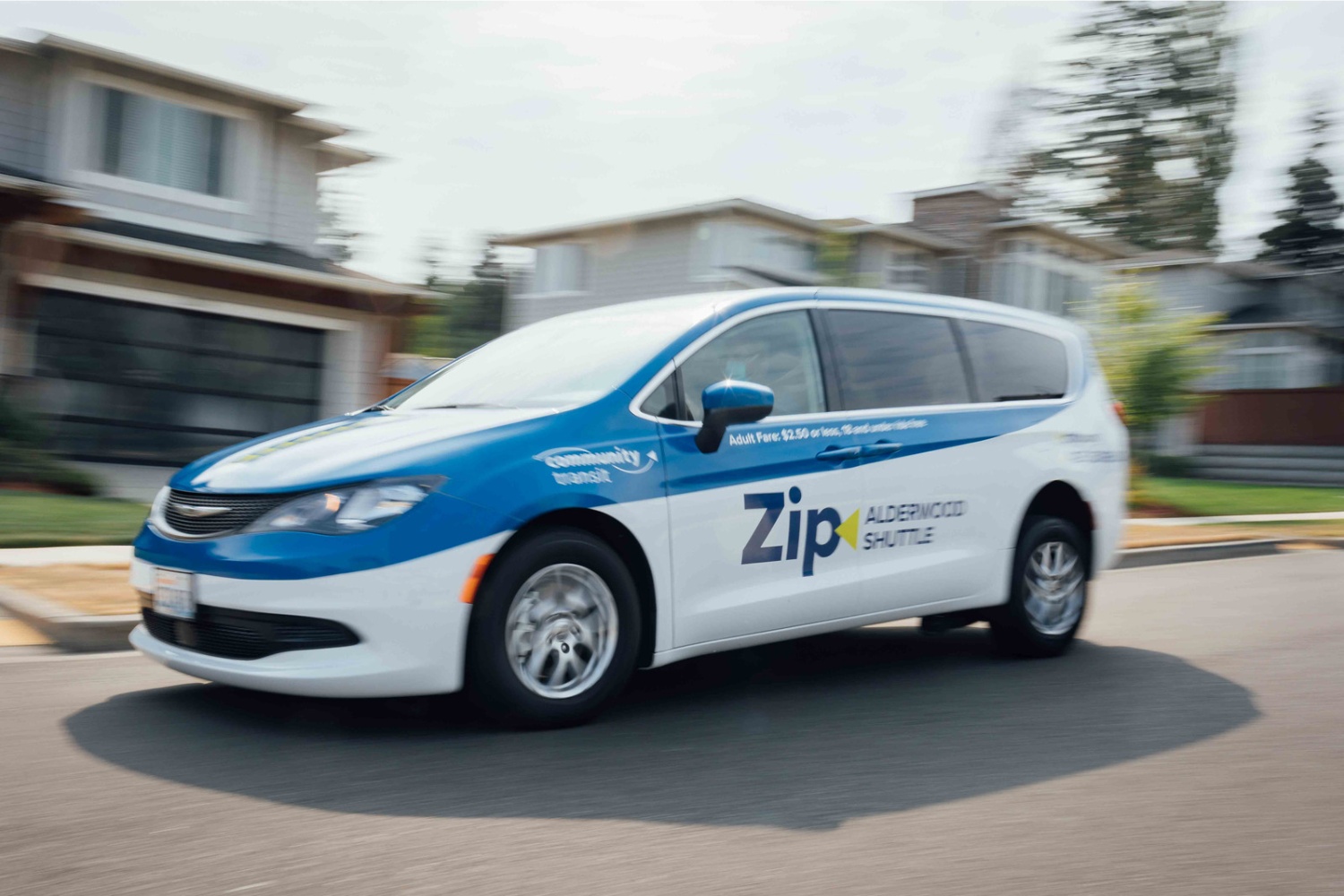 A Community Transit Zip Alderwood shuttle van parked on a residential street in Lynnwood WA.