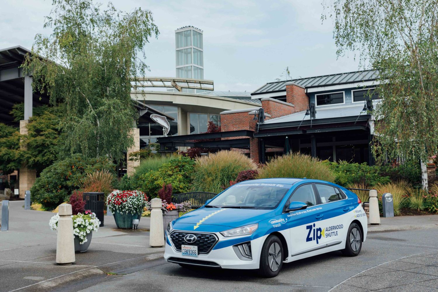 A Zip car parked in front of the Alderwood Mall.