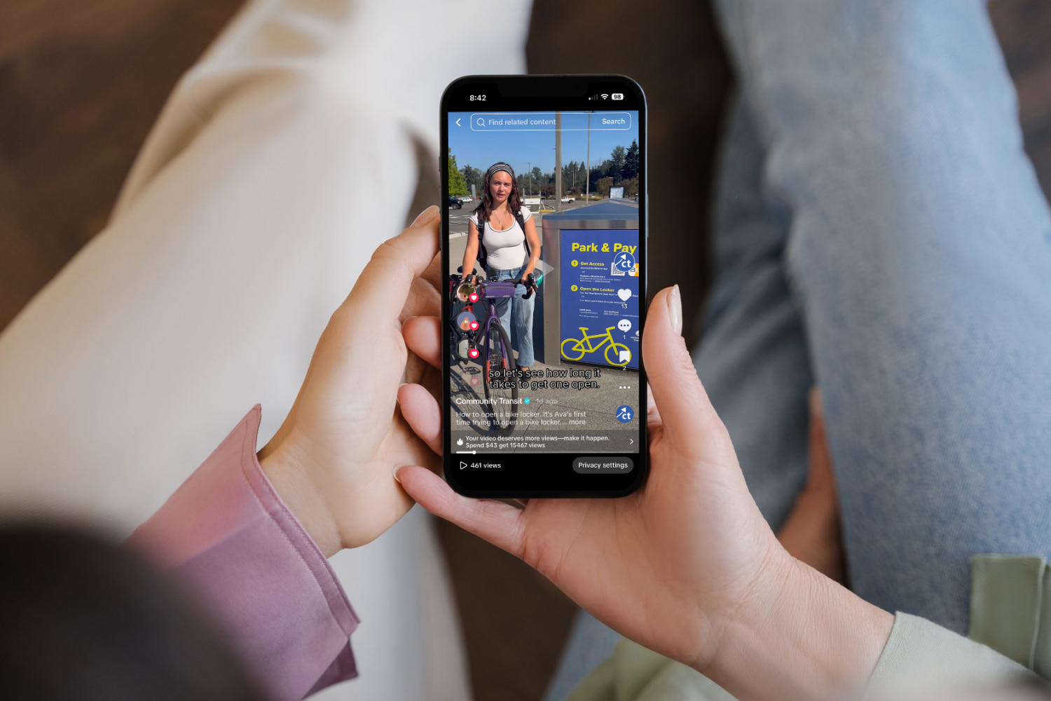 Focus is on two teen women holding a mobile phone, watching a Community Transit TikTok post.