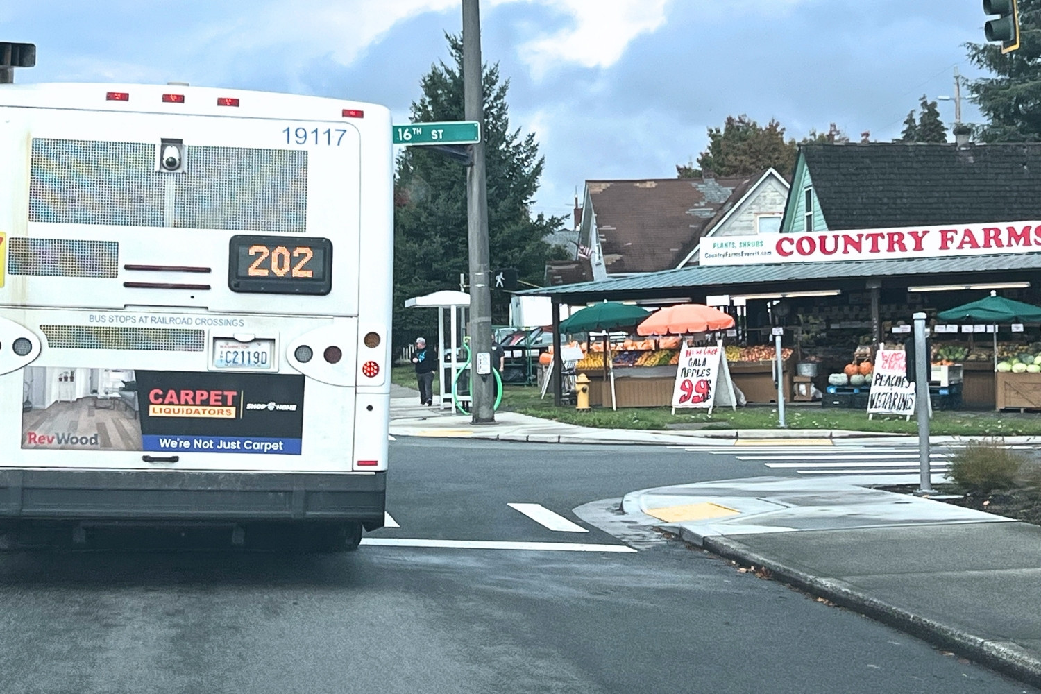 A Community Transit bus serving Route 202 drives by the Country Farms fruit and vegetable stand in Everett.