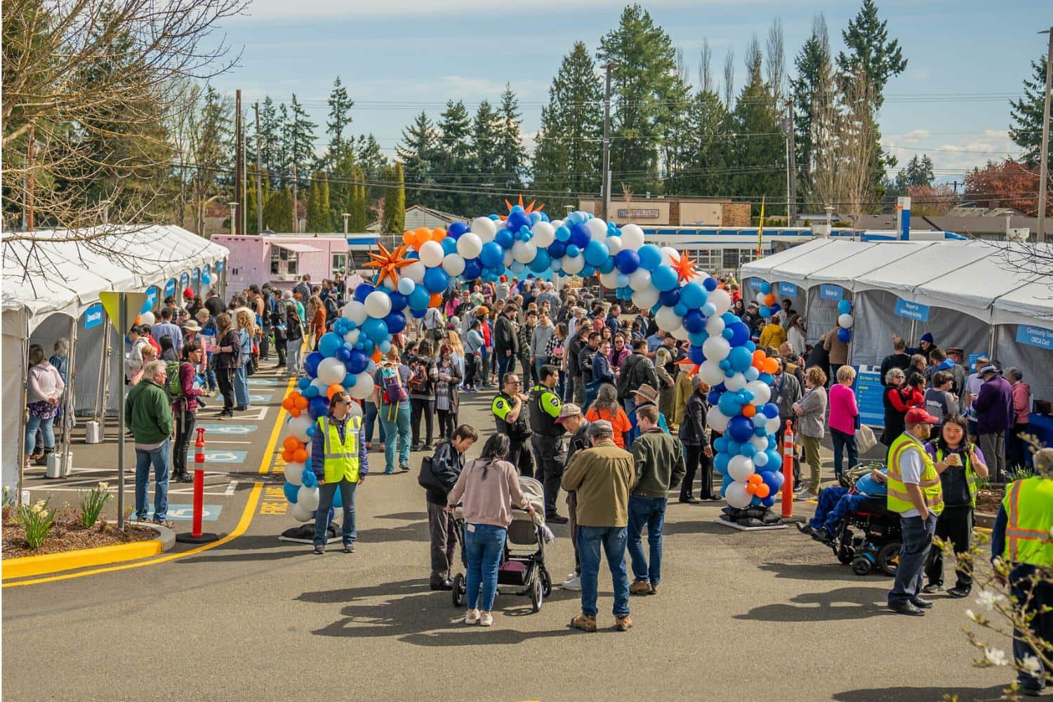 A scene from the Swift Orange Line Block Party on Saturday, March 30, 2024 at Edmonds College Tents, food trucks and a bright colored balloon archway greet crowds at the block party celebrating Swift Orange Line's first day of service on March 30, 2024