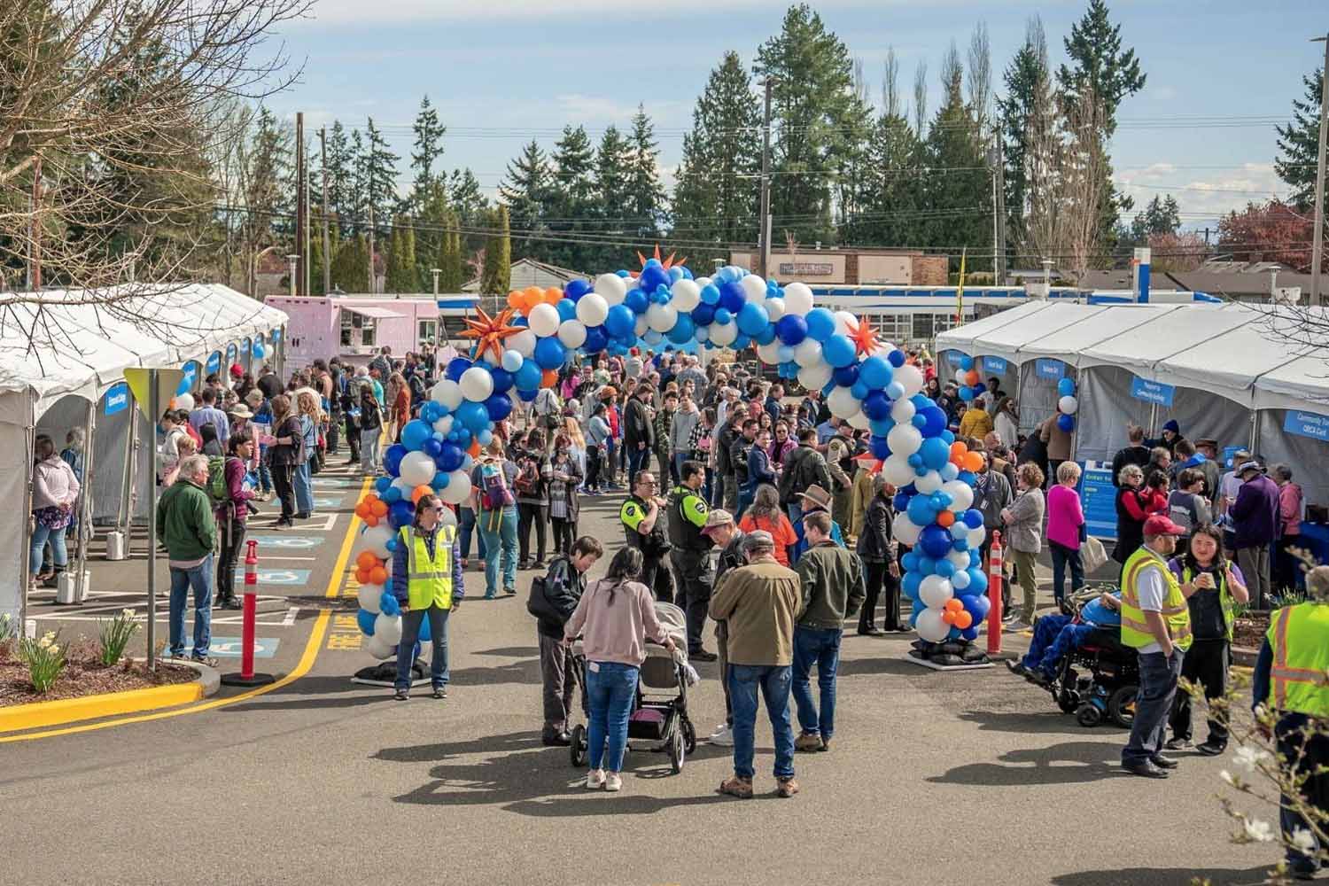 Tents, food trucks and a bright colored balloon archway greet crowds at the block party celebrating Swift Orange Line's first day of service on March 30, 2024