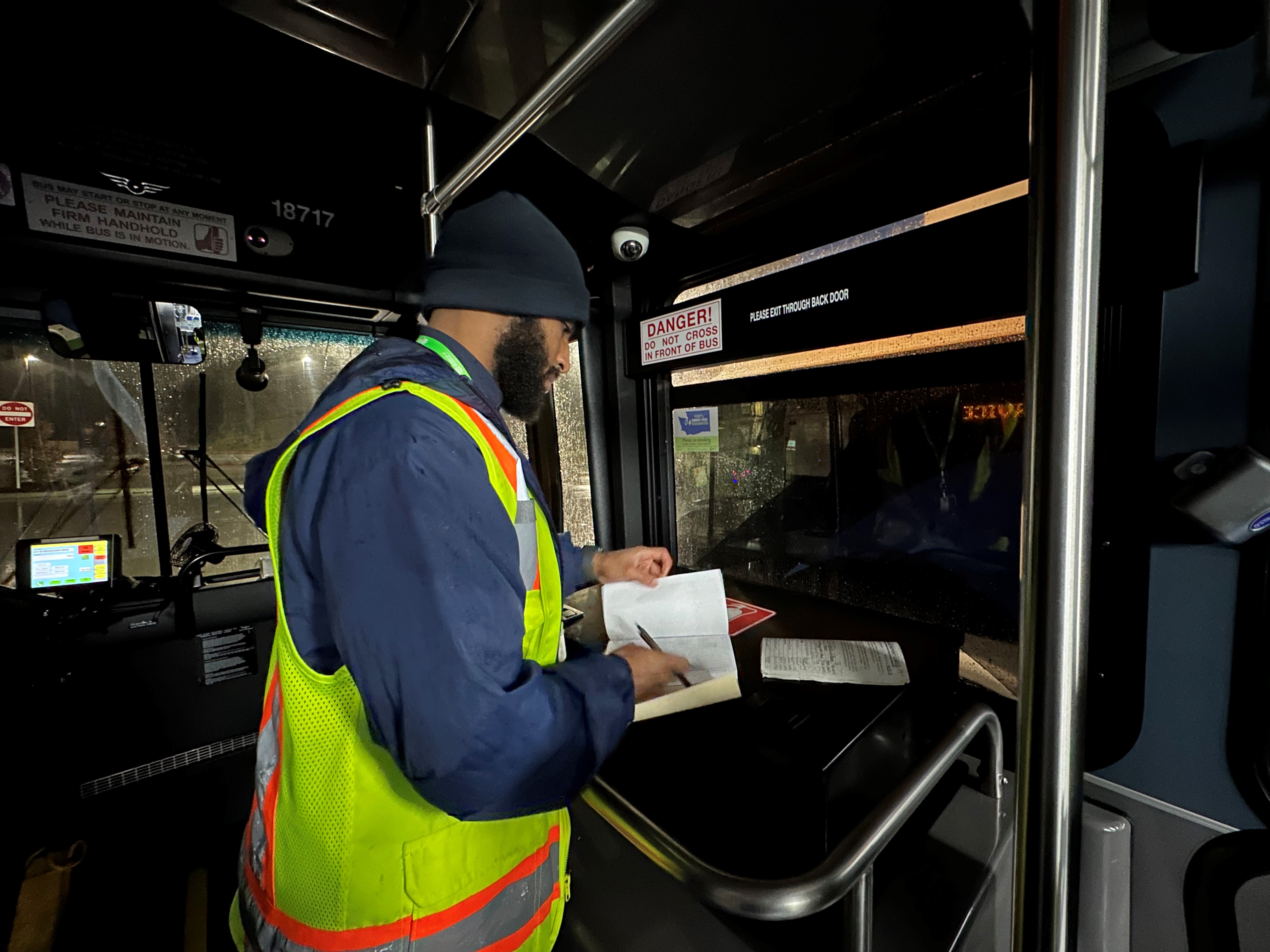 Community Transit driver Abraham Berhe performing a pre-check of his assigned bus before heading out on his route. 