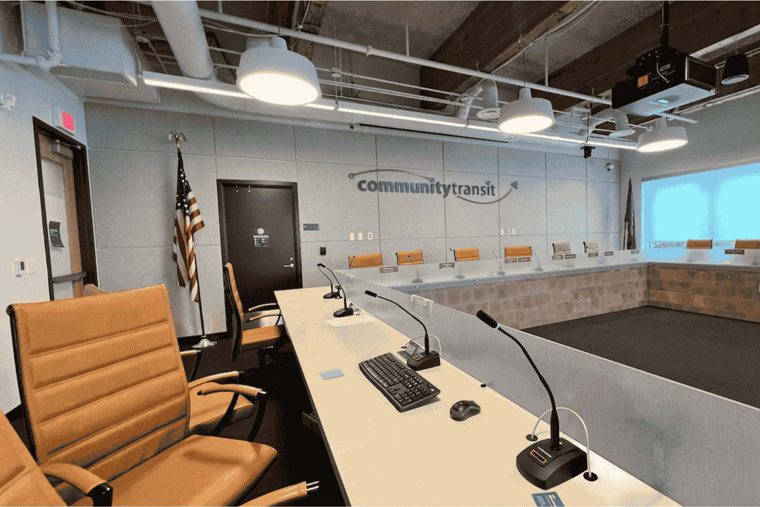 A shot of the dais in Community Transit's board conference room. Tan leather seats are empty.