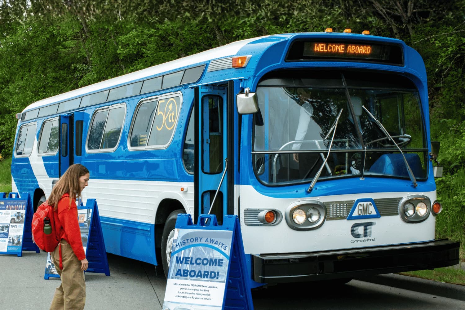 A young woman gets ready to board Bluebell, Community Transit's mobile museum and original bus.