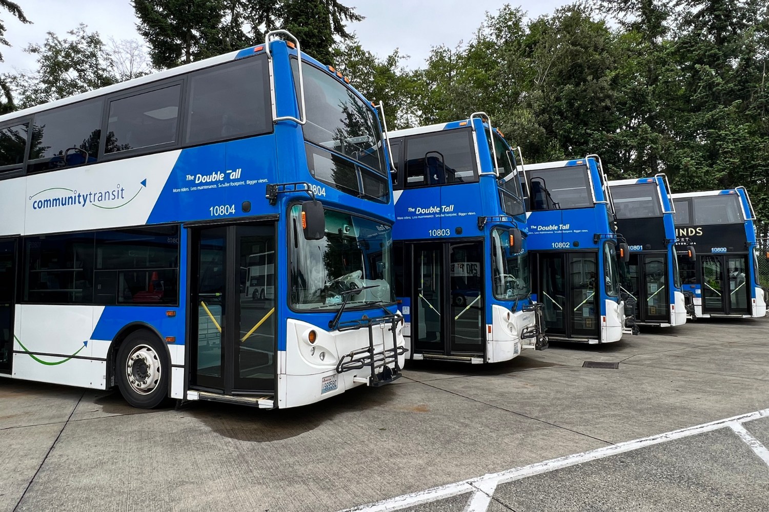 Five Community Transit double-decker buses parked side by side.