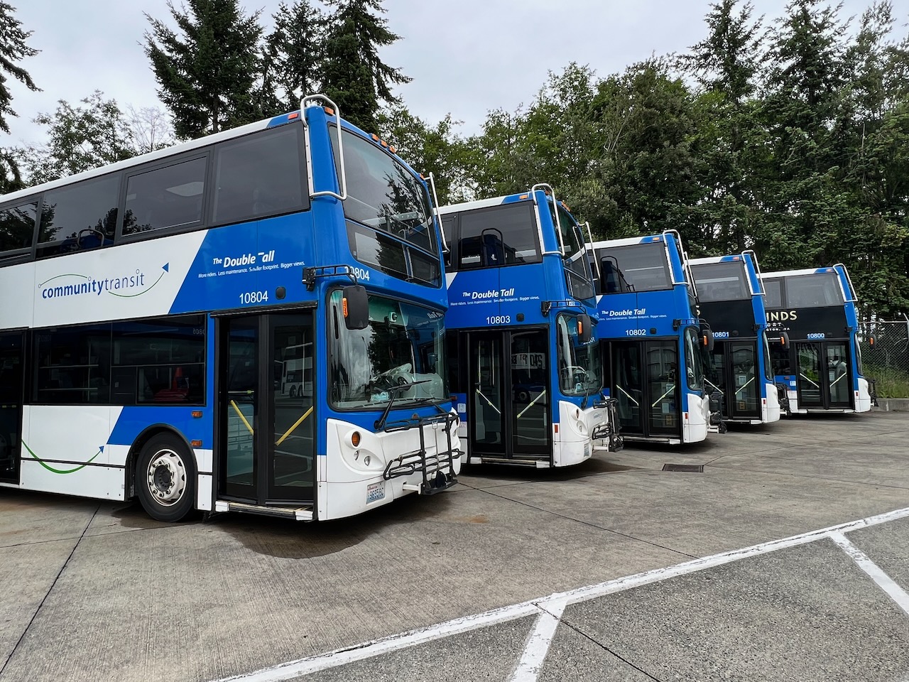 Five Community Transit Double Tall, double-decker buses parked diagonally in the bus yard.