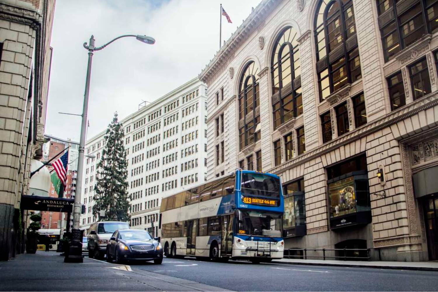 A Community Transit double decker, Double Tall bus serves Route 413 as it drives down Olive Way in downtown Seattle.