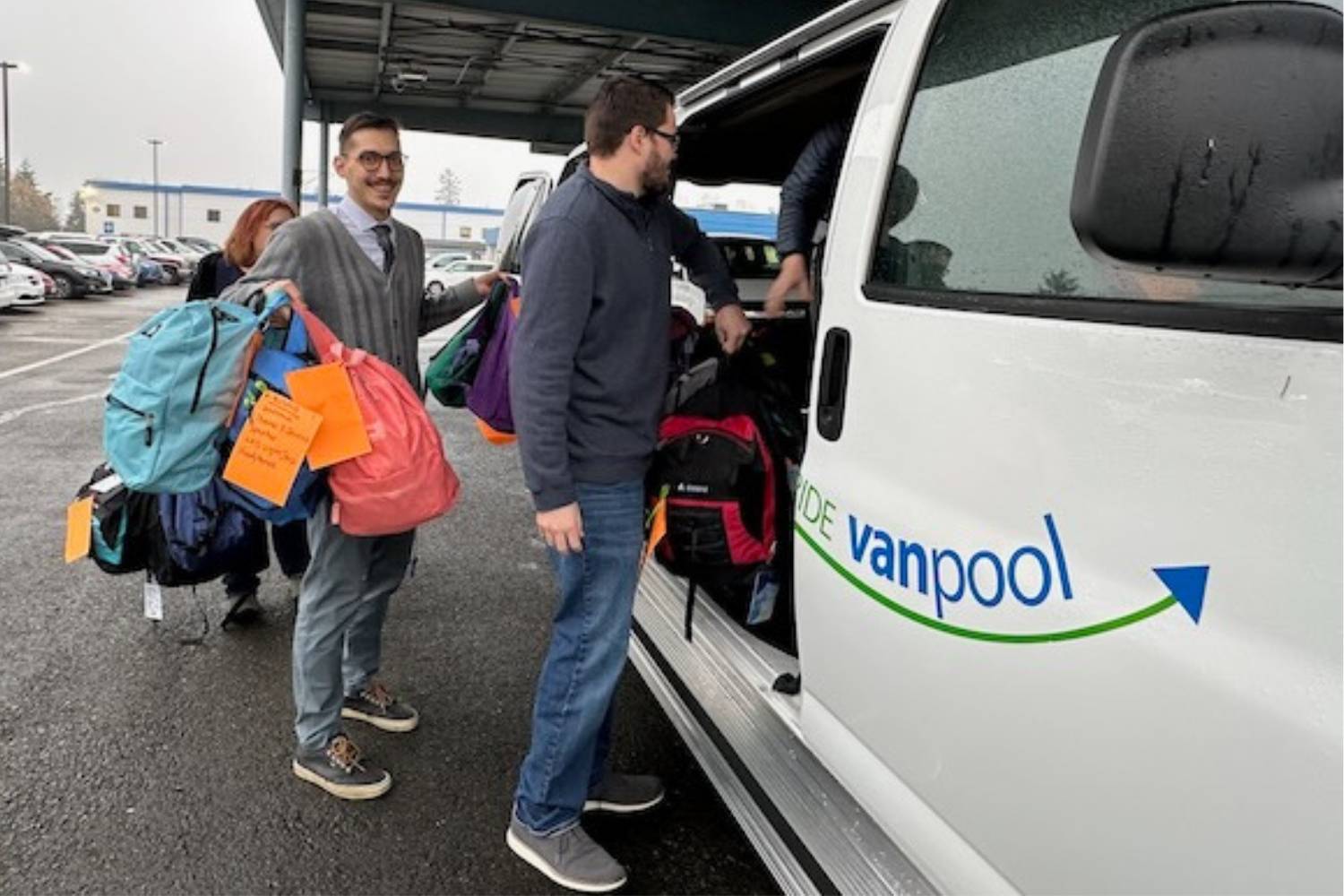 Community Transit employees loaded three vans with backpacks for delivery to area high schools.