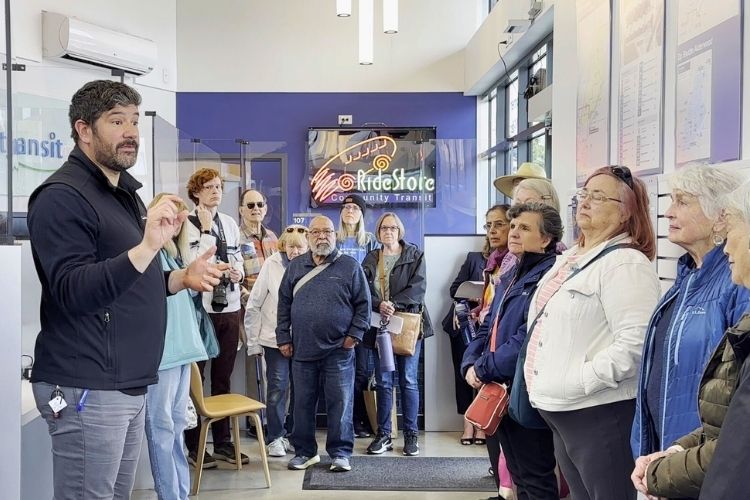 A man speaks to a group of older adults at the Ride Store in Lynnwood City Center