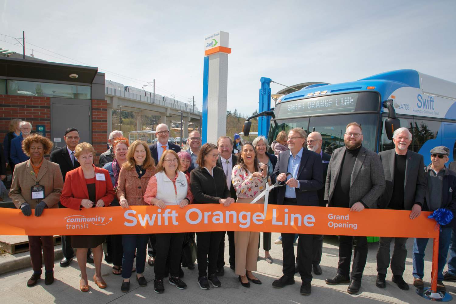 Federal Transit Administration (FTA) Acting Administrator Veronica Vanterpool holds scissors for ribbon-cutting at Community Transit Swift Orange Line opening ceremony at Lynnwood Transit Center.