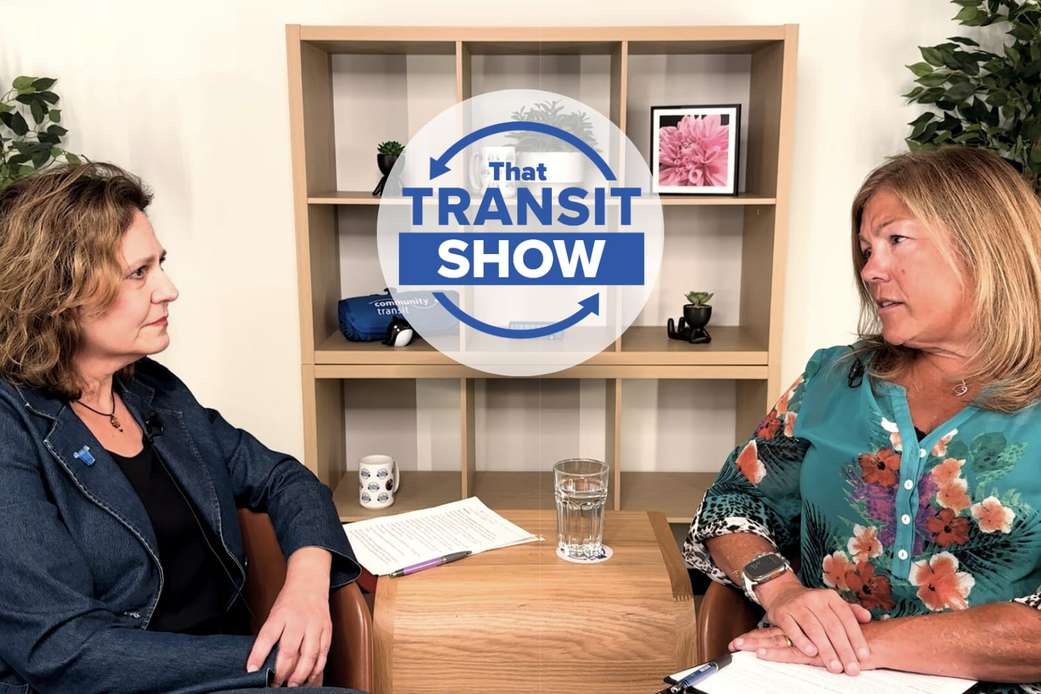 Two women sitting in a studio, talking about how food banks benefit from buses and community support.