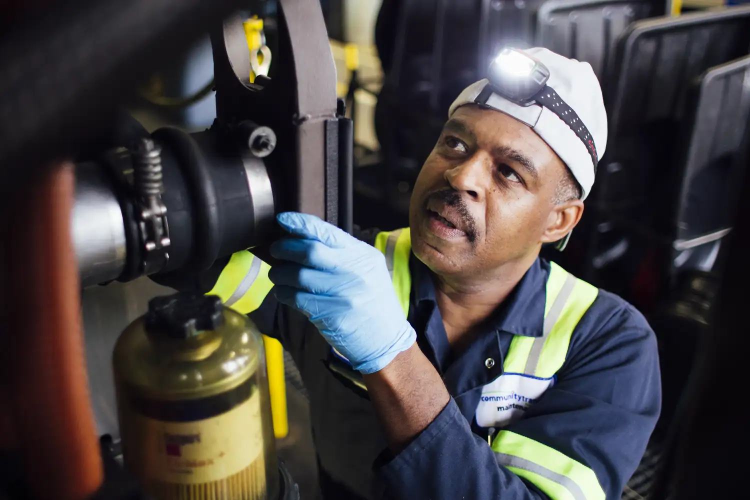 a Community Transit mechanic working on a bus