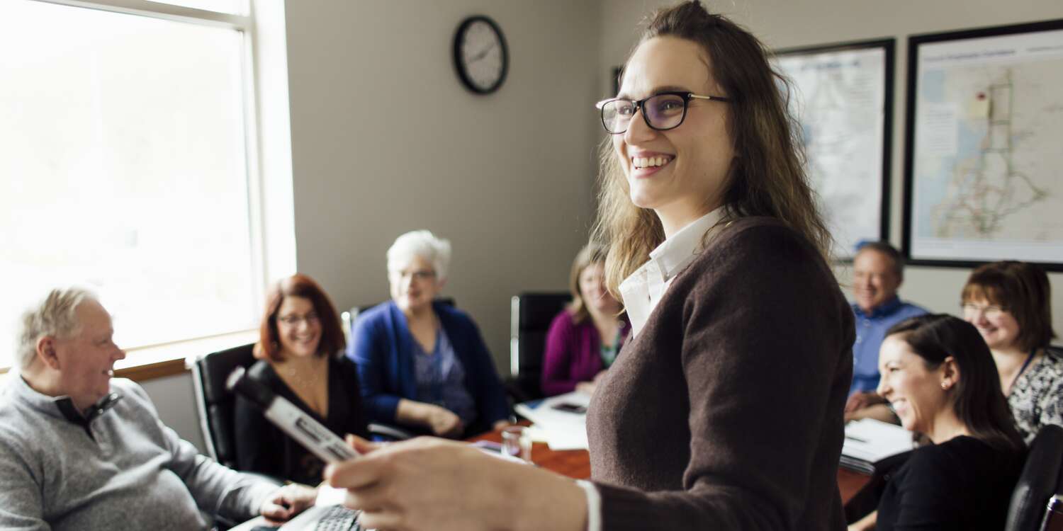 Employees sitting around a conference table.