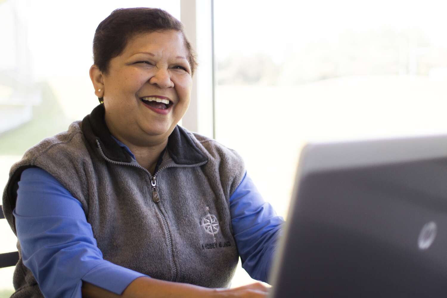 Smiling employee on laptop