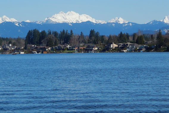 An image of Lake Stevens with the mountains in the background