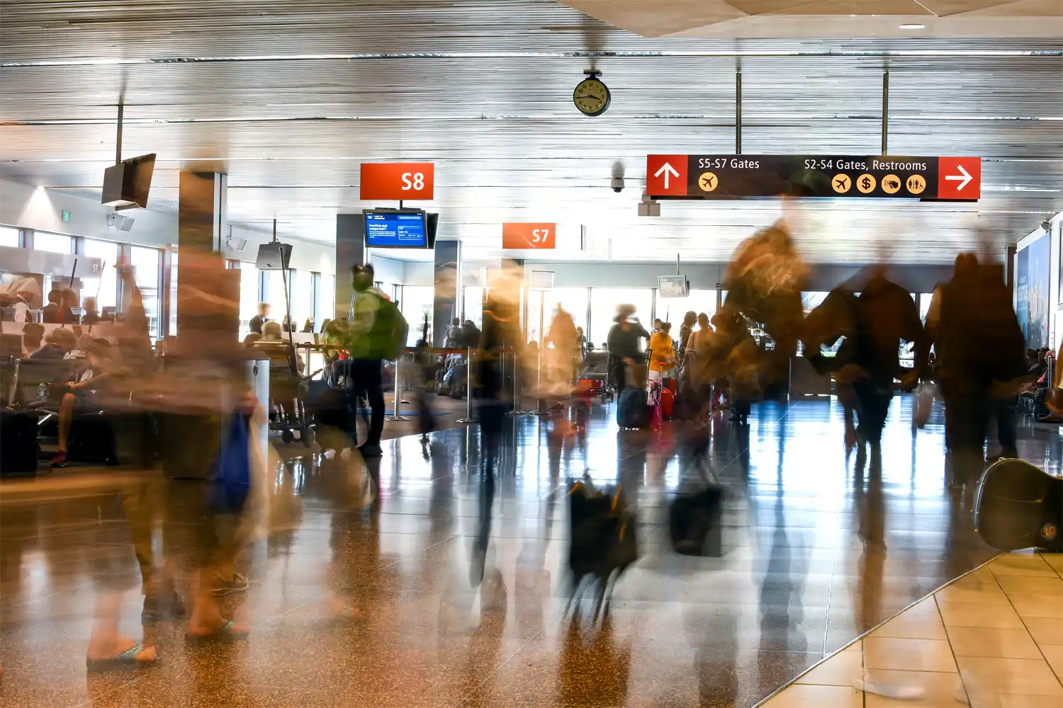 travelers inside one of the terminals in Sea-Tac Aiport