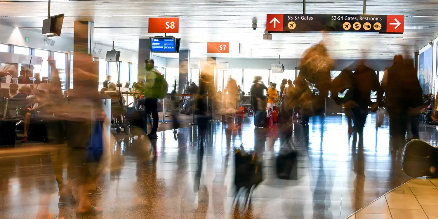travelers inside one of the terminals in SeaTac Aiport