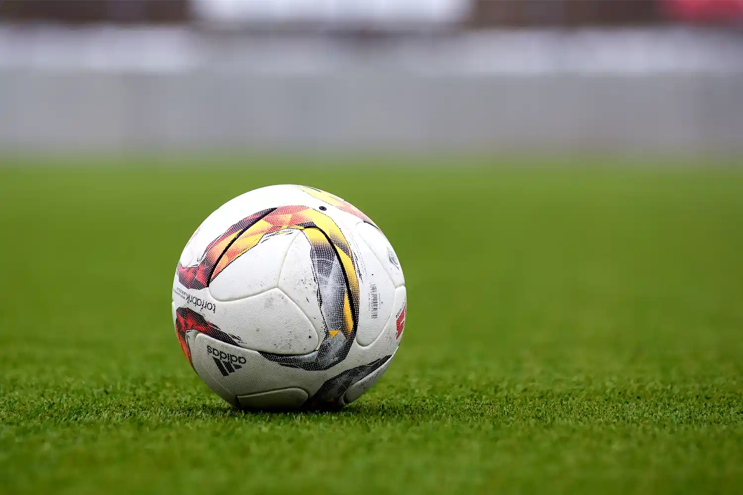 a soccer ball on a grass field. Photo credit: Peter Glaser, Wikimedia Commons