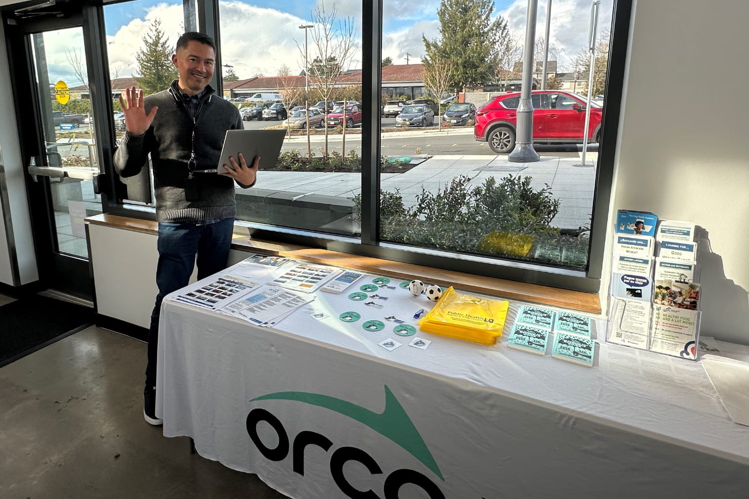 Smiling man at Community Transit Ride Store. He is providing in-person help for those needing ORCA LIFT and the subsidized pass.