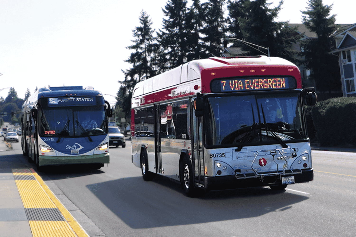 A Community Transit and Everett Transit bus travel along Evergreen Way in Everett, WA