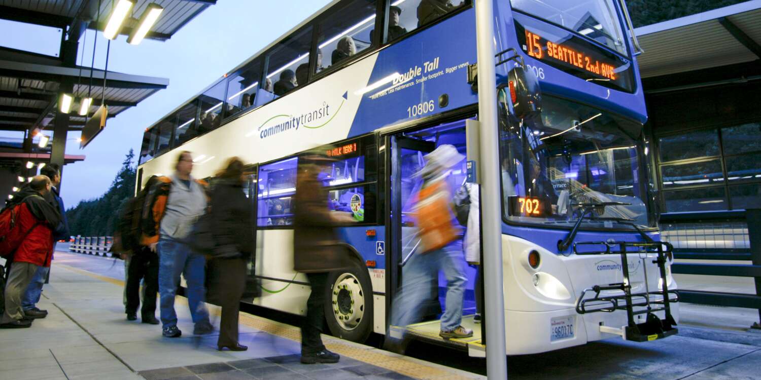 People getting on to a double decker Community Transit bus