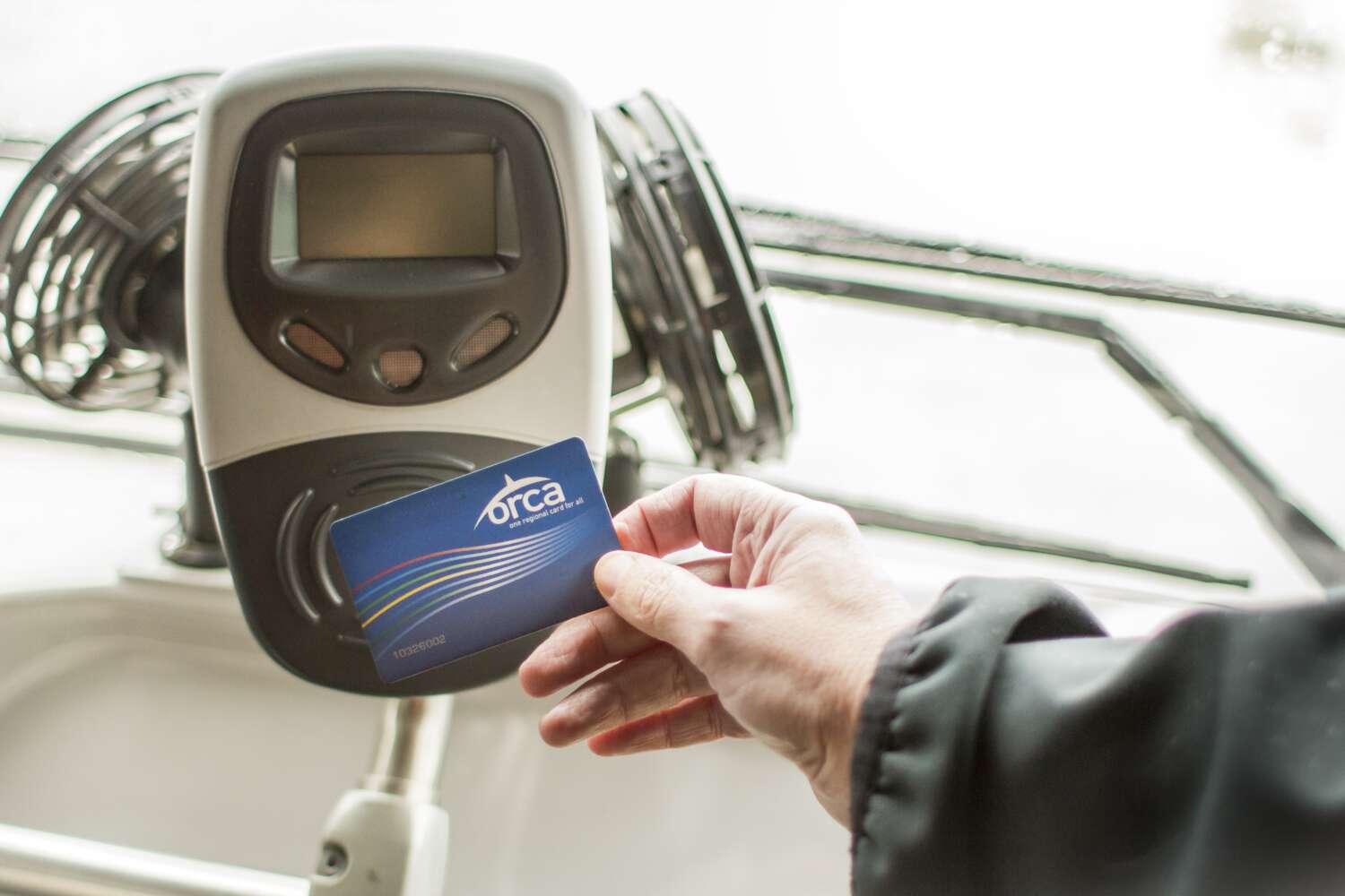 Rider uses ORCA card to boad a bus