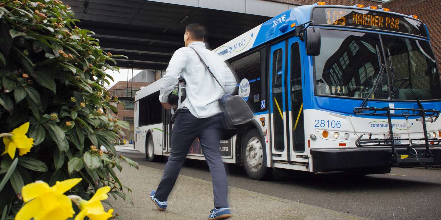 Man walks past a Community Transit bus