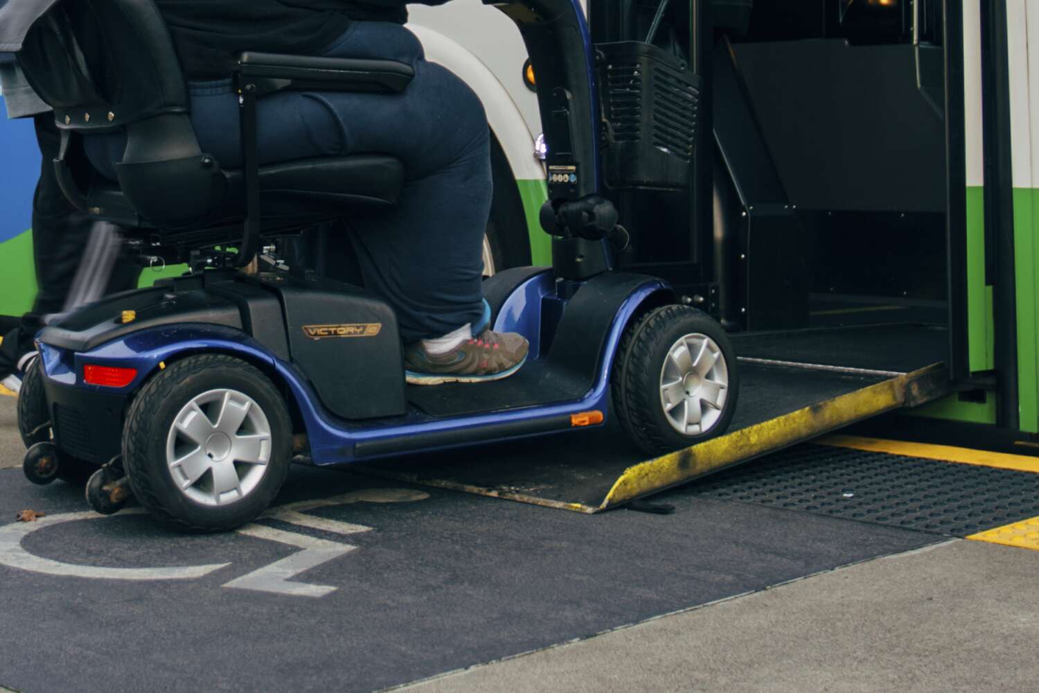 Rider with a mobility device entering bus