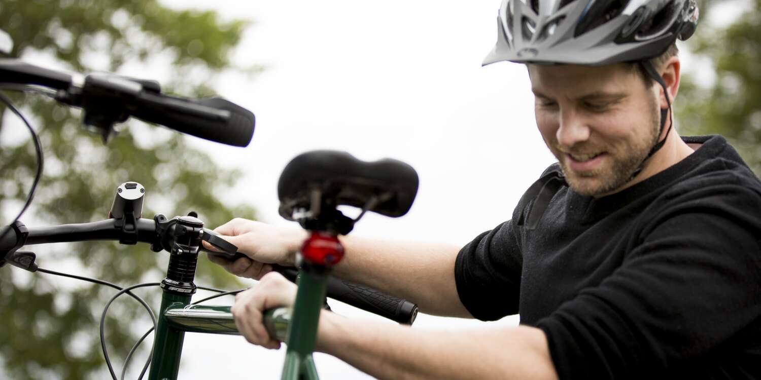 Rider puts his bik in a bike locker