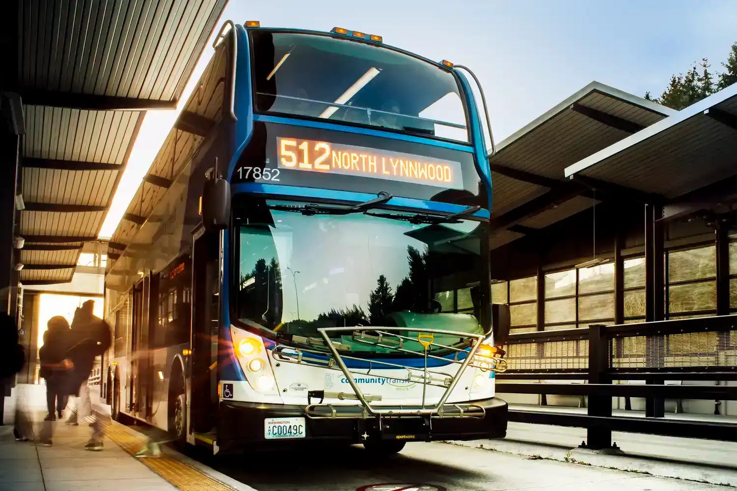 a double-tall express bus stopped at a transit center