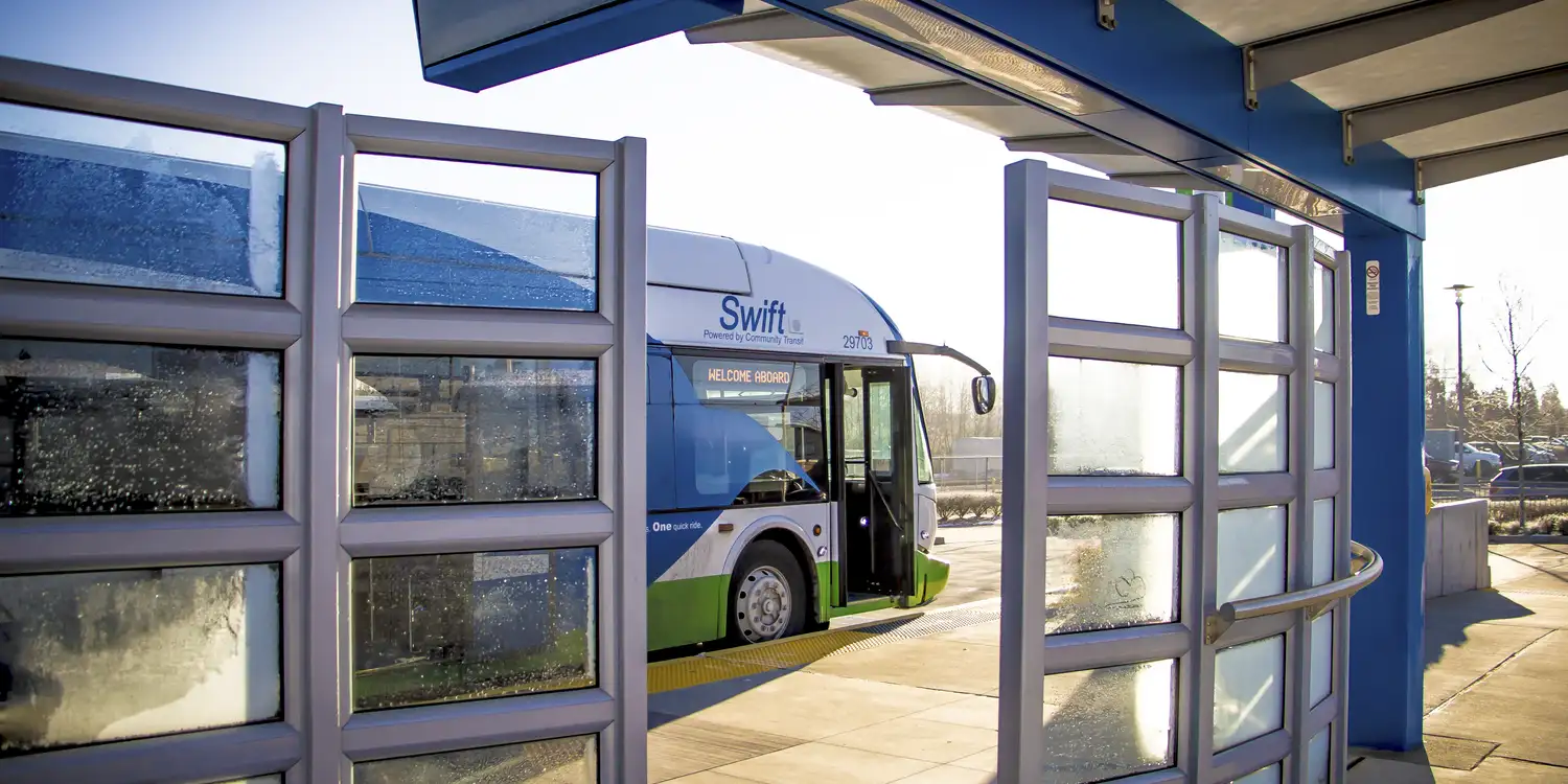a Swift bus viewed from a Swift station in the early morning
